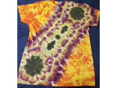 Black, purple, and green ripping through the shiret digonally with bright contrasting background colors.