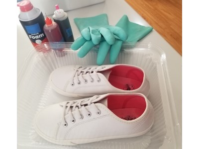 White shoes that have been soaked in soda ash and ready to be dyed using the shaving cream method