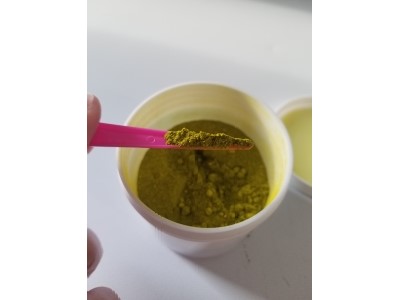 Small spoonful of dry lime green dye
