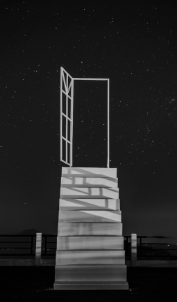 Open door with night sky behind it