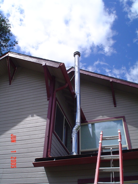 Triple wall chimney being put in place.