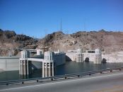 Dam and intake towers from Arizona side, note the curvature of the dam into the upstream side of the river.