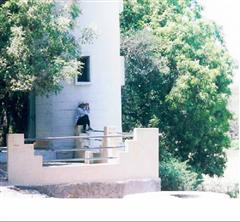 Sherlock Holmes of RD Group!!!!!!!!
S. Munirasu trying to find some birds through his telescope. 
(This photo was taken during our one day trip (April 2002) to Vedanthangal bird sanctuary, which is 85 kms from Chennai )