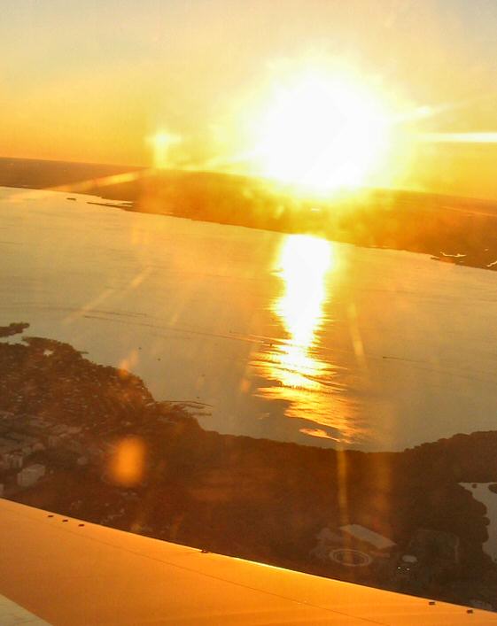 The science teachers always tell you not to look directly into the sun.  I figured I'd try to snap a shot as we banked around on final approach, and came away with this.
