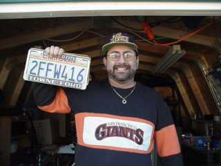 Jim holding California license plate.