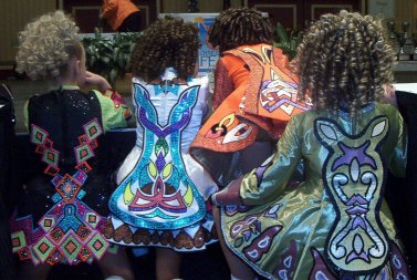 photo of girls in glittery dresses with geometric designs