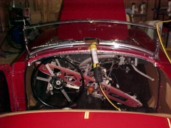 Dash and steering wheel lowered to disconnect wiring and remove choke, starter cable and temperature gauge ether tube.&nbsp; 