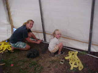 Liz and Carrie, lacing the bottom panel with rope, the last step.