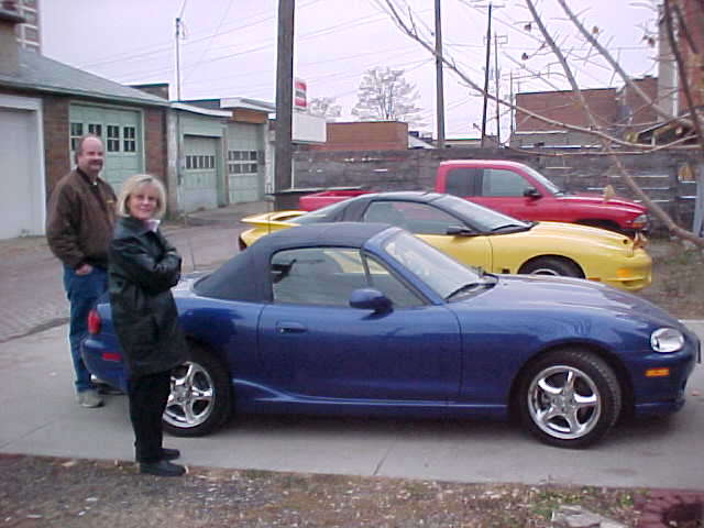 Bob and Cindy, with Miata and Bob's 2002 Trans Am in the background.