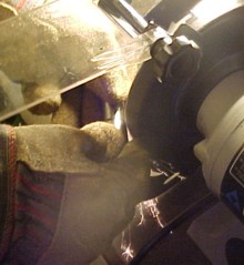 Bench grinder used to groove the distance pin, a hole was drilled through the groove to allow grease to the bolt.