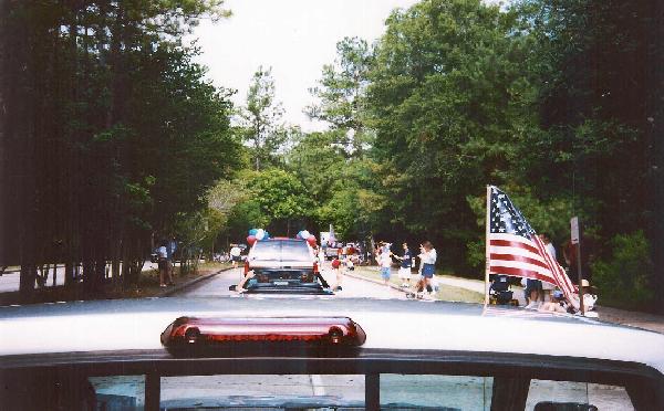 [Photo taken by candidate of parade along Timberloch Place, The Woodlands, July 4, 2004]