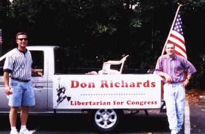[Scott Gordon and Gil Gullory stand by the float at the 
end of the July Fourth parade.]