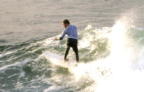 Here is a surfer cutn' up the wave to get the most for his run! Even riding through the "rough".