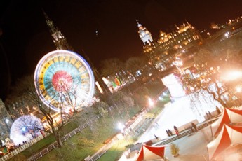 The Ferris Wheel, Scott Monument, and ice-skating rink in front of the Balmoral Hotel.
