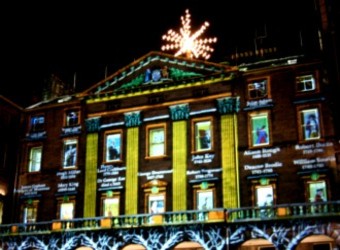 Ghosts of the Edinburgh dead, lit up in the windows of City Chambers with the city star overhead.