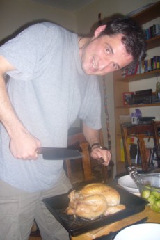 Alex preparing to carve the chicken.