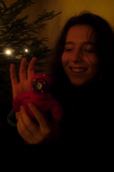 Marion happily sticking pins into the voodoo doll that Alex received from Santa.