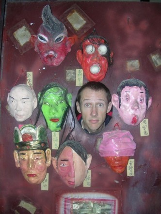 Picture of Daren Nicholson's face among several artistic masks