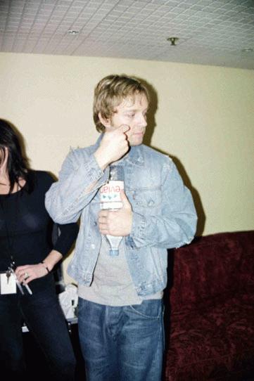 Why is Darren holding his bottle of Evian upside-down?? 