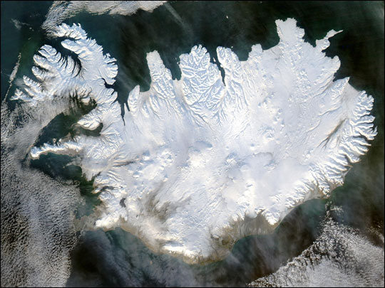 Color satellite photo of Iceland covered in glaciers.