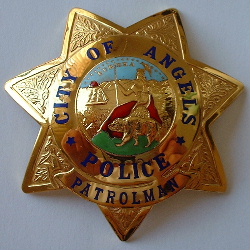 Past issue City of Angels Police star. The City of Angels Camp is located in the foothills of the Sierra Madre mountain range famed for its gold mines. Rather than be called Angels Camp Police the police department calls itself the City of Angels Police. The badge is hallmarked  Ed Jones 