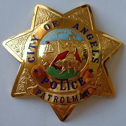Past issue City of Angels Police star. The City of Angels Camp is located in the foothills of the Sierra Madre mountain range famed for its gold mines. Rather than be called Angels Camp Police the police department calls itself the City of Angels Police. The badge is hallmarked&nbsp; Ed Jones 