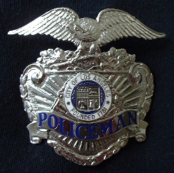 Past issue LAPD "Policeman" cap badge hallmarked "Entenmann, Los Angeles". Obsolete title