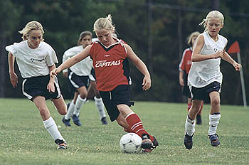 Melissa dribbles through the Strikers