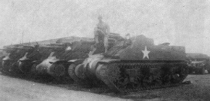 M7's and Half-tracks lined up in motor pool