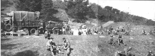 Mess truck serves chow - soldiers eating on hillside