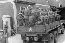 Six by Six troop truck loaded with soldiers