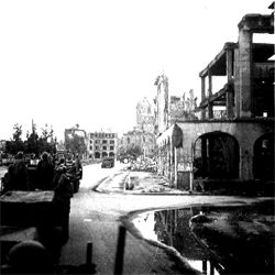 Convoy through bombed out city