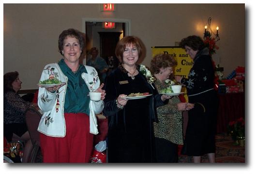 Parliamentarian Carol Schiavone (left) and President Darlene Adams (right) enjoy their Christmas dinner.