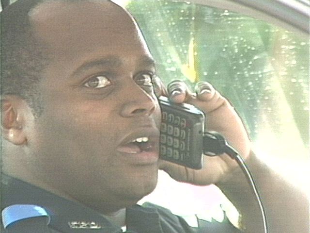 Burt suddently realizes the mistake of driving and talking on the cell phone. 
