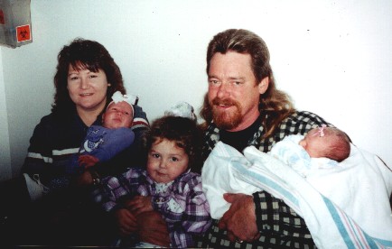 Grandma Christie holding Ashlynn,& Grandpa Sherman holding Elise and newborn Abigail