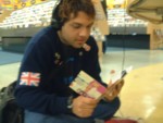 Michael on the floor of hte whearhouse exchange. They are too poor to buy stools. 