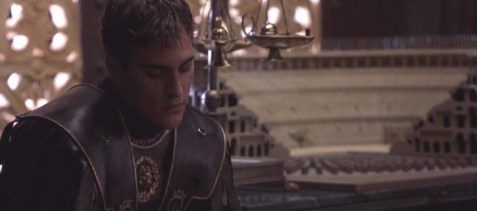Commodus sitting on the bed