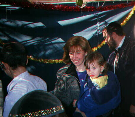 Chabad Rabbi Chuni Vogel & Rebbitzin Oryah Vogel with family in Sukkah
