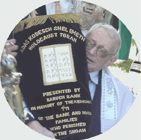 Former European DP Bernie (Baruch) Bank holds Sefer Torah he saved from WW II