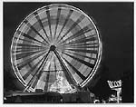 Black and white shot of a ferris wheel taken at night