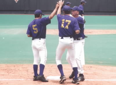 CJ, Noah, Brandon ritual high 5 before they go onto the field