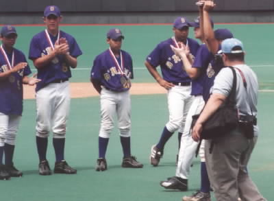 Seniors hold up the trophy. That darn guy wouldn't get out of the way!!