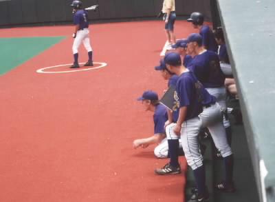 The dugout watching the batter. CJ #5 is on deck.