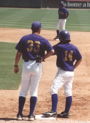 Coach Langfeld talking to Nick on 1st base while James waits on 2nd.