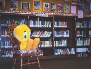 Tweety Bird in rocking chair in library