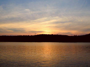 A Red Sunset through clouds reflected on a lake