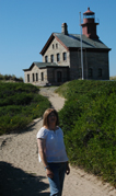 The red brick North Shore Lighthouse with me standing in front of it