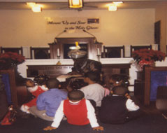 Our Church Mother, Mildred Watson reading the Christmas story to the children at their Christmas service, December, 2006
