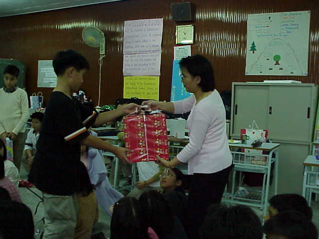 Shaun presenting Mrs Ang with x'mas present