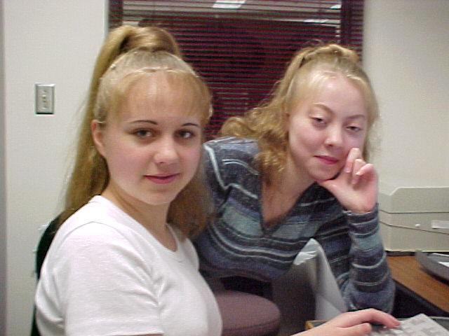 A high school student and her sister sitting at the computer
